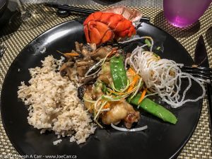 Ginger and garlic wok-seared lobster with sake-braised oyster and shiitake mushrooms, brown rice at the Tamarind restaurant